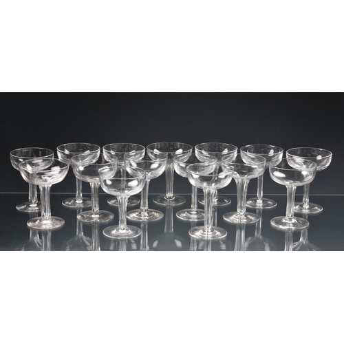 73 - *** WITHDRAWN *** A well matched set of fourteen Edwardian hollow stem champagne saucers, the drawn,... 