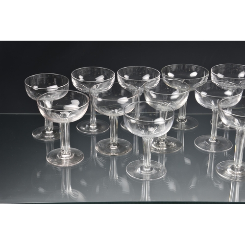 73 - *** WITHDRAWN *** A well matched set of fourteen Edwardian hollow stem champagne saucers, the drawn,... 