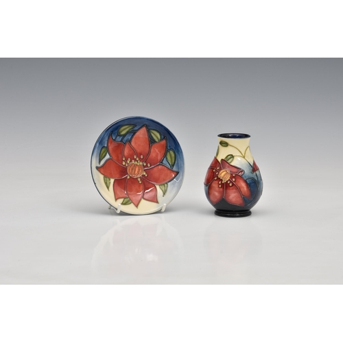 8 - A miniature Moorcroft Pottery vase and dish, varying marks to bases, floral decoration on blue into ... 