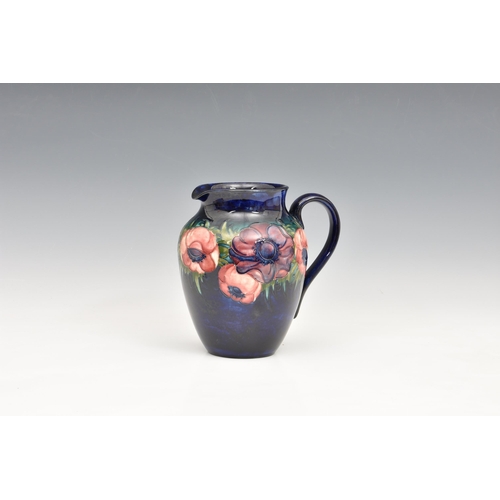 9 - A Moorcroft Pottery jug, 'anemone' pattern, dark blue ground, , blue signature marks 'Potter to the ... 