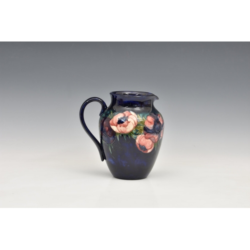 9 - A Moorcroft Pottery jug, 'anemone' pattern, dark blue ground, , blue signature marks 'Potter to the ... 