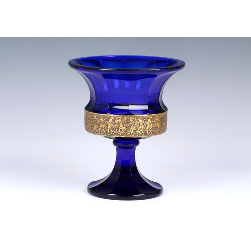 91 - A Moser cobalt blue glass urn with flared rim, acid cut neo classical gilt freeze encircling the bas... 