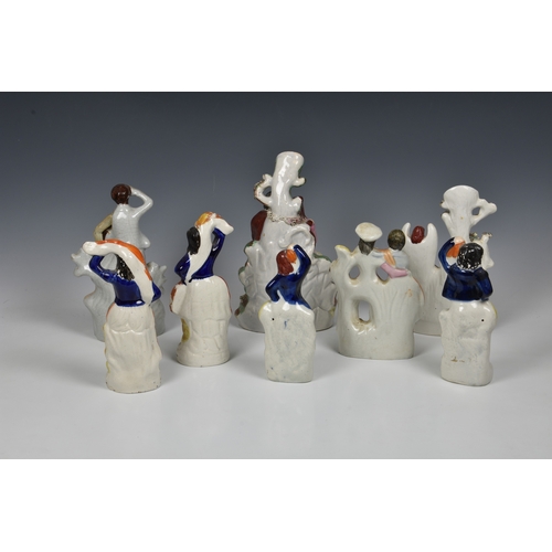 57 - A collection of 19th century Staffordshire figural groups, of couples and dancers, of varying forms ... 