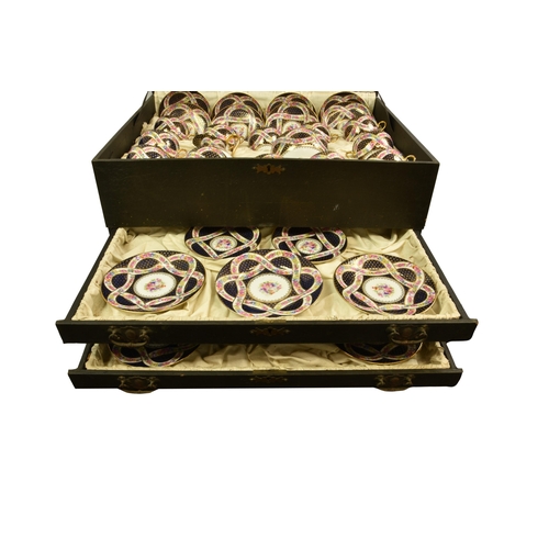 65 - A cased Bohemian porcelain dessert or luncheon service, for twelve settings, each piece centred by a... 