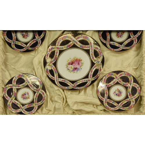 65 - A cased Bohemian porcelain dessert or luncheon service, for twelve settings, each piece centred by a... 