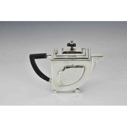 253 - A mid-twentieth century Art Deco style silver teapot, indistinct marks, probably Indian, of stylised... 