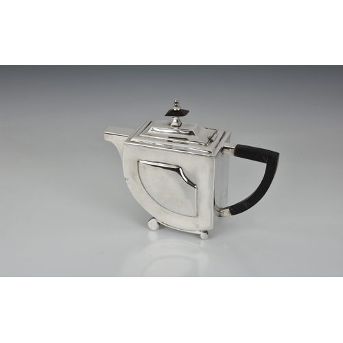 253 - A mid-twentieth century Art Deco style silver teapot, indistinct marks, probably Indian, of stylised... 