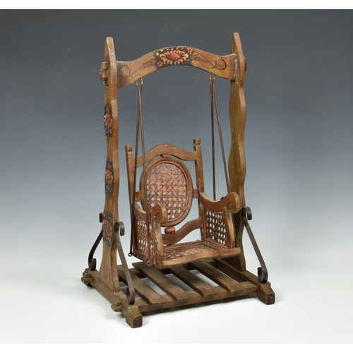 1774 - A painted wooden and rattan dolls swing seat, second half 20th century, the frame decorated with dai... 