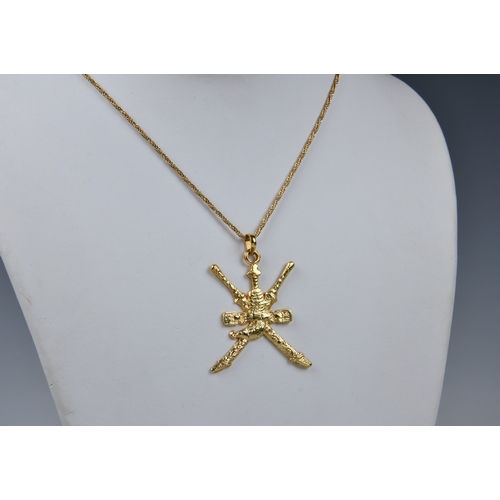 1020 - A 22ct gold Omani khanjar pendant, the national symbol of Oman, on a 25in. 18ct yellow gold palma li... 