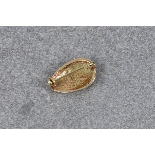 1110 - A 9ct gold ormer shell brooch by Nina Paint of Guernsey, hallmarked 'N.P. Guernsey 9ct', 23mm. long.... 