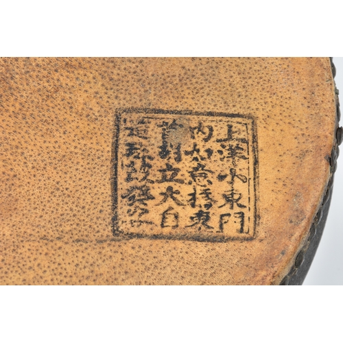 1504 - A Japanese Taiko war drum, probably 19th century, the brass rivetted, vellum skins with black painte... 