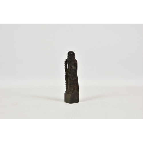 1510 - A Chinese carved, mottled dark brown soapstone carving of Shou Lao, the God of Longevity, carrying a... 