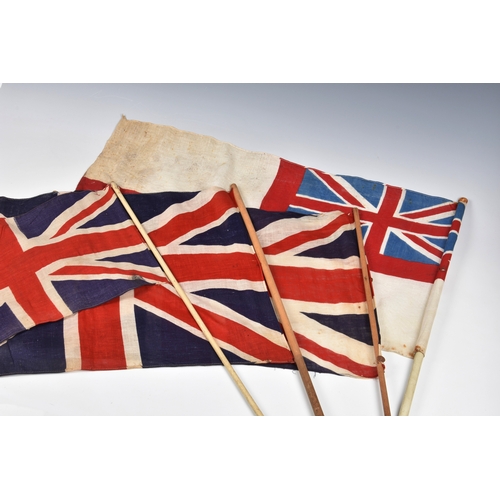 2029 - Three 1940s handheld Union jack linen flags, the largest 27 15in. (68.z x 38.2cm.), together with a ... 