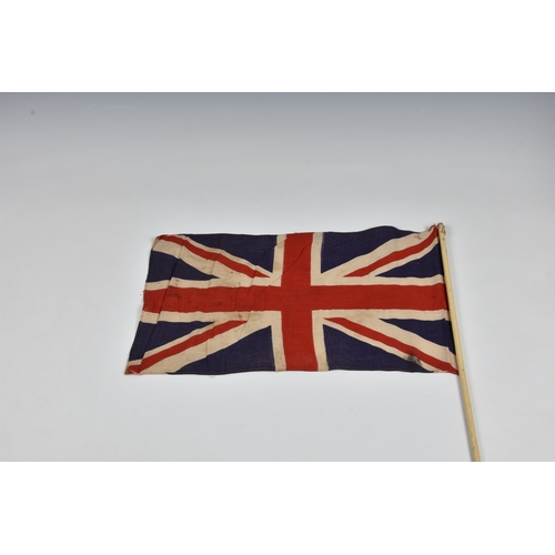 2029 - Three 1940s handheld Union jack linen flags, the largest 27 15in. (68.z x 38.2cm.), together with a ... 