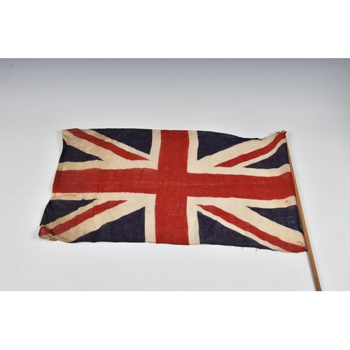 2029 - Three 1940s handheld Union jack linen flags, the largest 27 15in. (68.z x 38.2cm.), together with a ... 