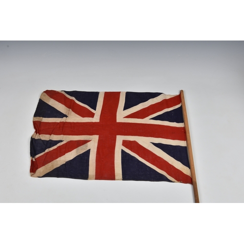 2029 - Three 1940s handheld Union jack linen flags, the largest 27 15in. (68.z x 38.2cm.), together with a ... 