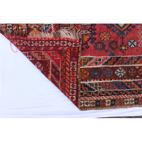 2188 - A Tekke Bokhara rug, on a red brick ground with three rows of thirteen elephants foot Guls separated... 