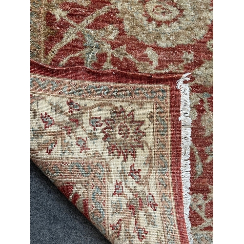 2191 - A Herati style rug, on red ground, with central floral motif and palmette borders, faded, 77 x 62in.... 