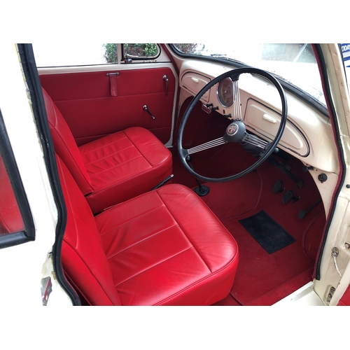 1770 - A 1960 Morris Minor Convertible, cream paintwork with red pinstripe, contrasting red interior and bo... 