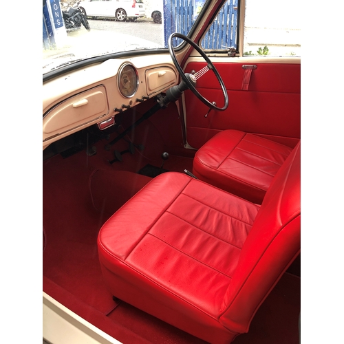 1770 - A 1960 Morris Minor Convertible, cream paintwork with red pinstripe, contrasting red interior and bo... 