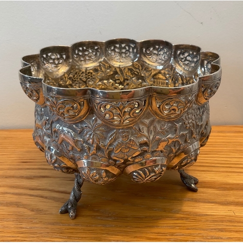 13 - A footed Indian silver bowl, of shaped circular lobed form, raised on three entwined fish feet, with... 