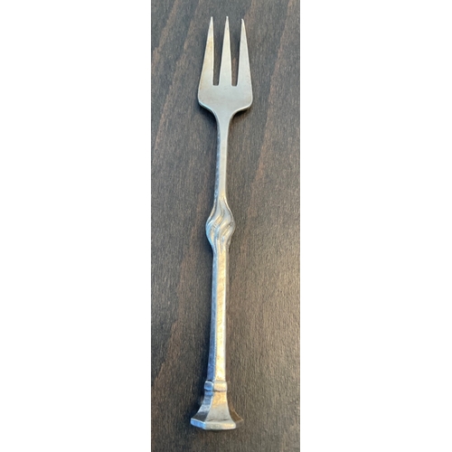 29 - Omar Ramsden and Alwyn Carr - A rare Arts and Crafts silver pickle fork, London, 1913, planished and... 