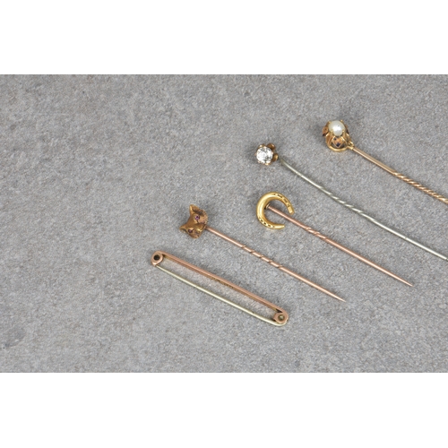 820 - Eight antique stick and tie pins, (some gold), to include a 18ct gold foxes head & 18ct gold miniatu... 