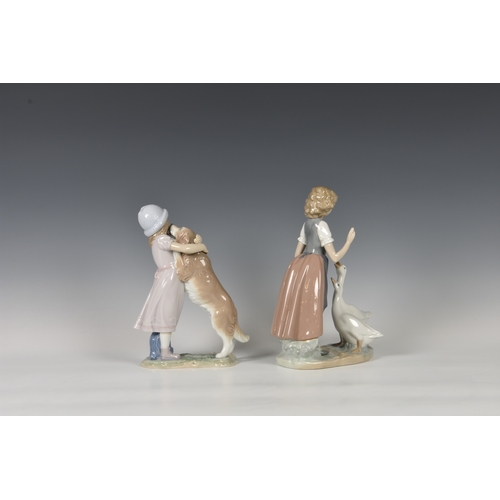 104 - A Lladro figurine 'A Warm Welcome', modelled as a girl and dog, printed and stamped marks, 10in. (25... 