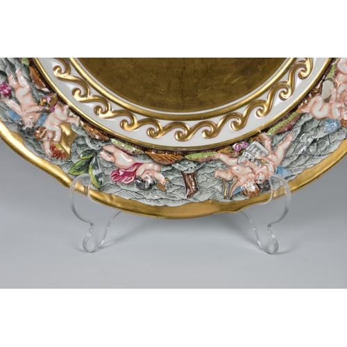 11 - A 19th century Capodimonte porcelain gilded cherub plate, relief decorated in a neoclassical style, ... 