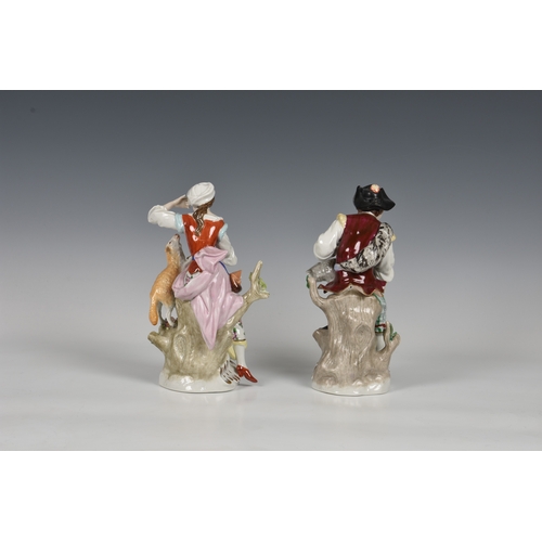 120 - A pair of Sitzendorf figures of a shepherd & shepherdess, early 20th century, both modelled sitting ... 