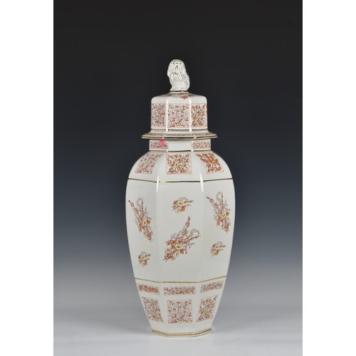 121 - A octagonal floor vase and cover, the central decoration depicting two ladies amidst grapevine, and ... 