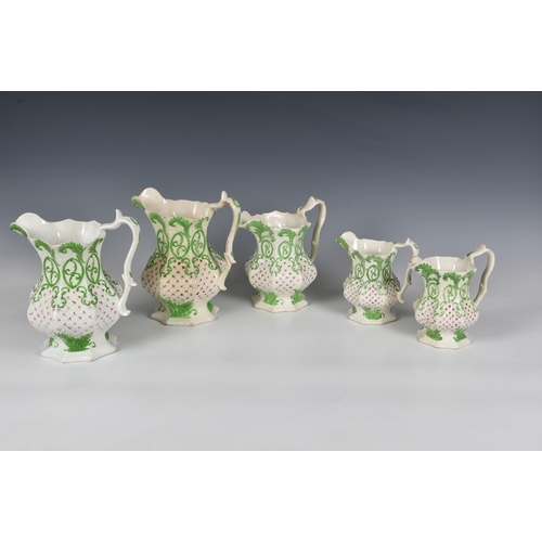 134 - A graduated set of four Victorian relief moulded jugs, of octagonal form, decorated with stylised gr... 