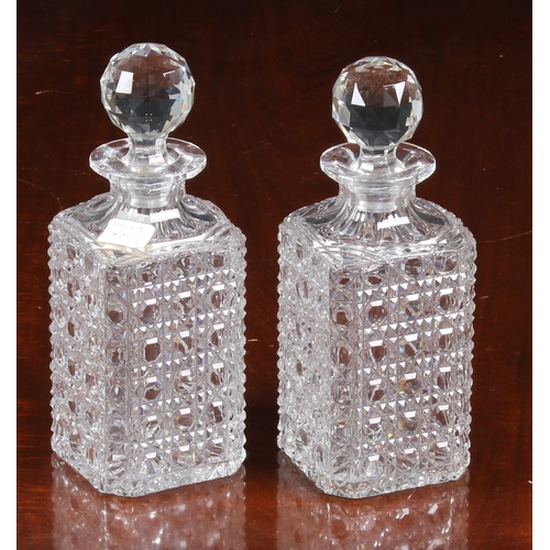 150 - A pair of Georgian oval pint decanters, with panel, diamond and prismatic cut bodies and necks with ... 