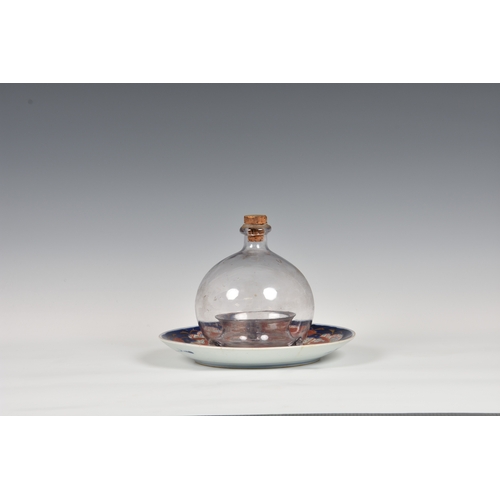 171 - A 19th century blown glass fly or wasp trap, of typical form with cork stopper, 6¼in. (15.8cm.) high... 