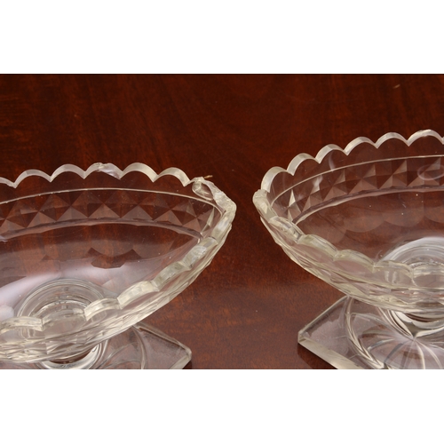 174 - A pair of Georgian cut glass navette pedestal dishes, on knopped stems and raised on round stepped b... 