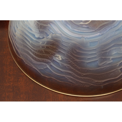 178 - A Lalique opaline glass 'Dauphins' bowl, with multiple species of impressed fish, swimming among spi... 