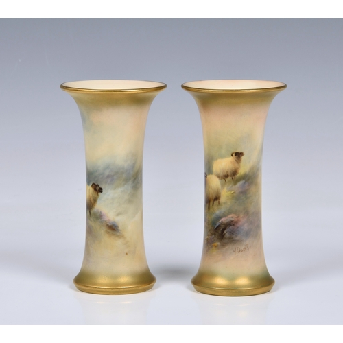 3 - A pair of Royal Worcester porcelain sheep painted trumpet spill vases by Harry Davis, each painted w... 