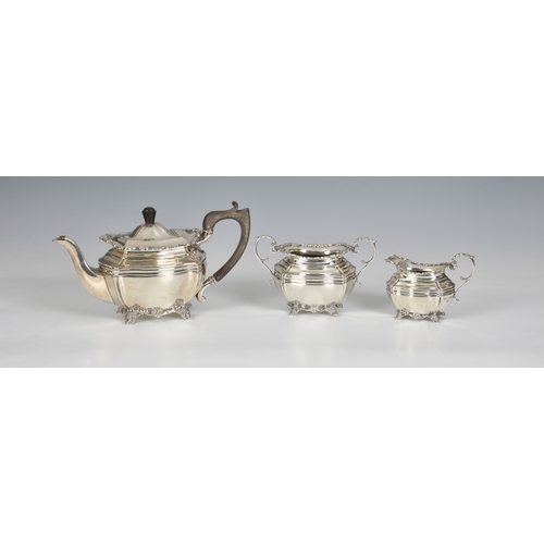 426 - An Edwardian silver three piece bachelor's tea service, Josiah Williams & Co., London 1911, retailer... 