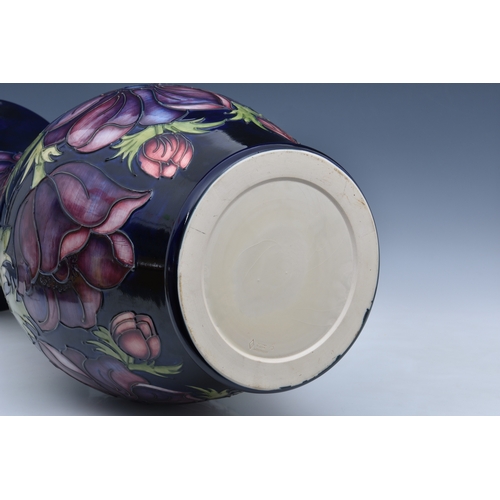 51 - A large Moorcroft Pottery floor standing baluster vase, with flared rim, 'anemone' pattern, on blue/... 