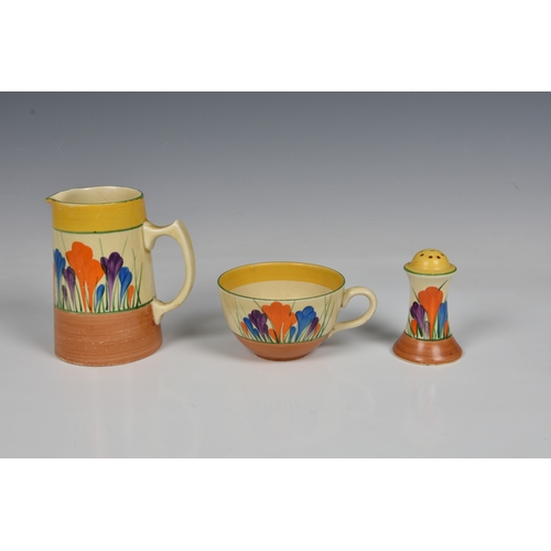 76 - Clarice Cliff Crocus pattern cup and saucer and matching small jug, with associated pepper pot, cup ... 