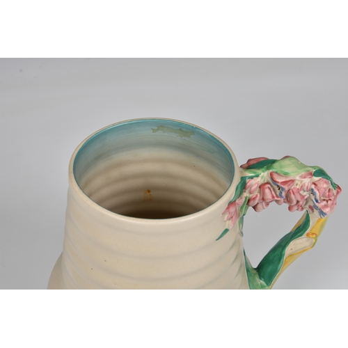 78 - A Clarice Cliff jug, c.1936, moulded floral, leaf and stem handle, ribbed body, printed Newport Pott... 