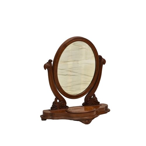 793 - A Victorian mahogany toilet mirror, the oval mirror on scroll carved supports on a serpentine base w... 