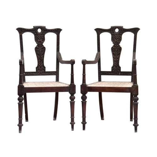 804 - A pair of 19th century Anglo-Indian carved hardwood open armchairs, possibly padouk wood, carved wit... 