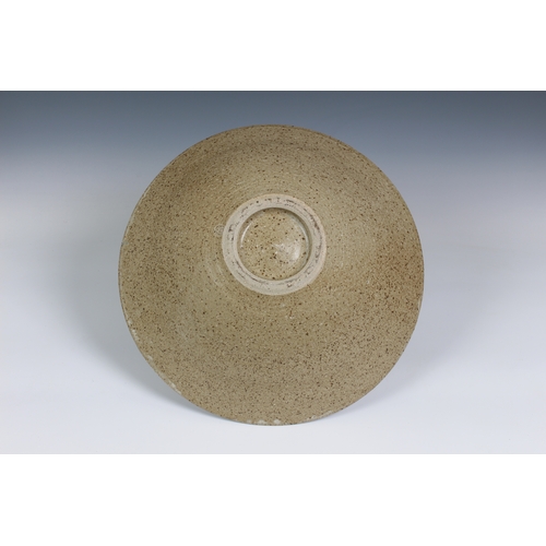 99 - Peter Arnold for Alderney Pottery, a late 20th century studio pottery footed bowl, in a mottled buff... 