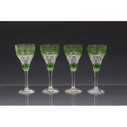 146 - A set of four John Walsh etched and green cased wine glasses, first half-20th century, the bowls wit... 