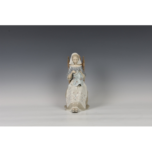 101 - A large Lladro figurine 'embroiderer', woman modelled sitting doing embroidery, printed and stamped ... 