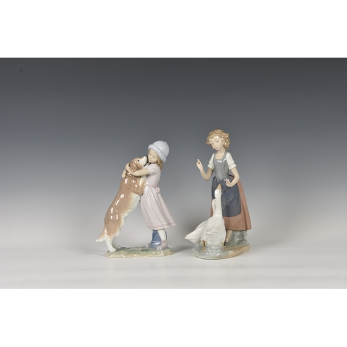 104 - A Lladro figurine 'A Warm Welcome', modelled as a girl and dog, printed and stamped marks, 10in. (25... 