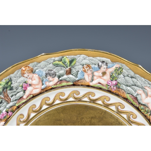 11 - A 19th century Capodimonte porcelain gilded cherub plate, relief decorated in a neoclassical style, ... 