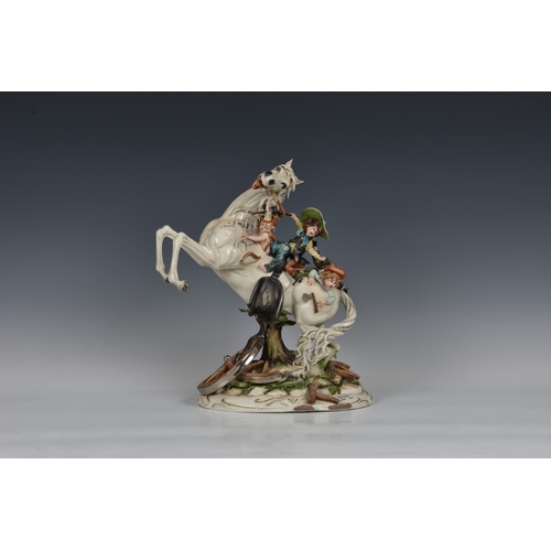 114 - A Capodimonte porcelain group of children on horseback, titled 'Far West', by Tiziano Galli, 14½in. ... 