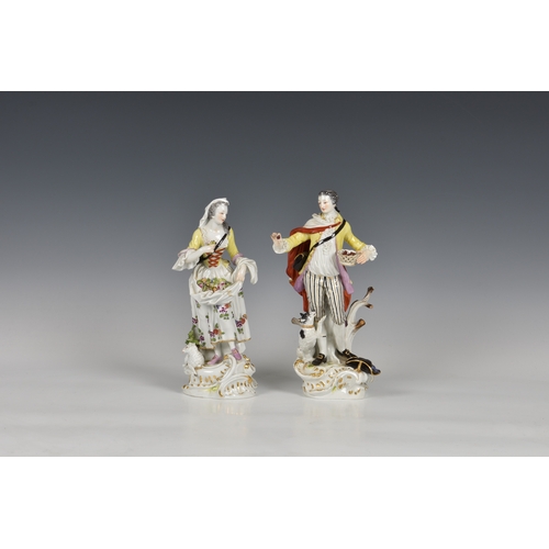 118 - A pair of Meissen figures of a gallant and his companion, early 20th century, the man holding a bask... 